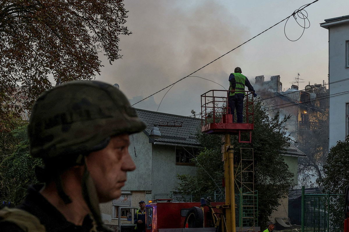 <i>Roman Baluk/Reuters via CNN Newsource</i><br/>Municipal workers check power lines at a site of a residential building damaged during a Russian drone and missile strike