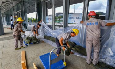 Windows and doors are taped as Hong Kong braces for the arrival of Typhoon Yagi.