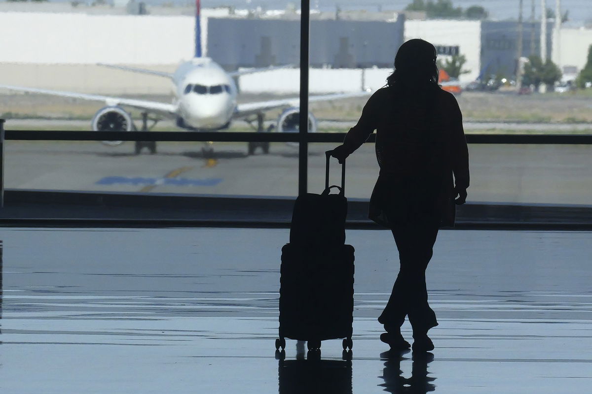 <i>Rick Bowmer/AP via CNN Newsource</i><br/>A holiday traveler looks out at an airplane at Salt Lake City International Airport over the July 4 holiday weekend. Frequent flyer programs have become a crucial part of the airline industry’s profitability.