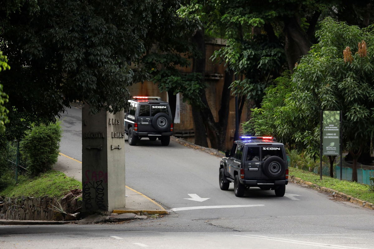 <i>Leonardo Fernandez Viloria/Reuters via CNN Newsource</i><br/>Vehicles of the Bolivarian National Intelligence Service (SEBIN) are seen on September 7 driving by the street of the Argentine ambassador's residence in Venezuela's capital