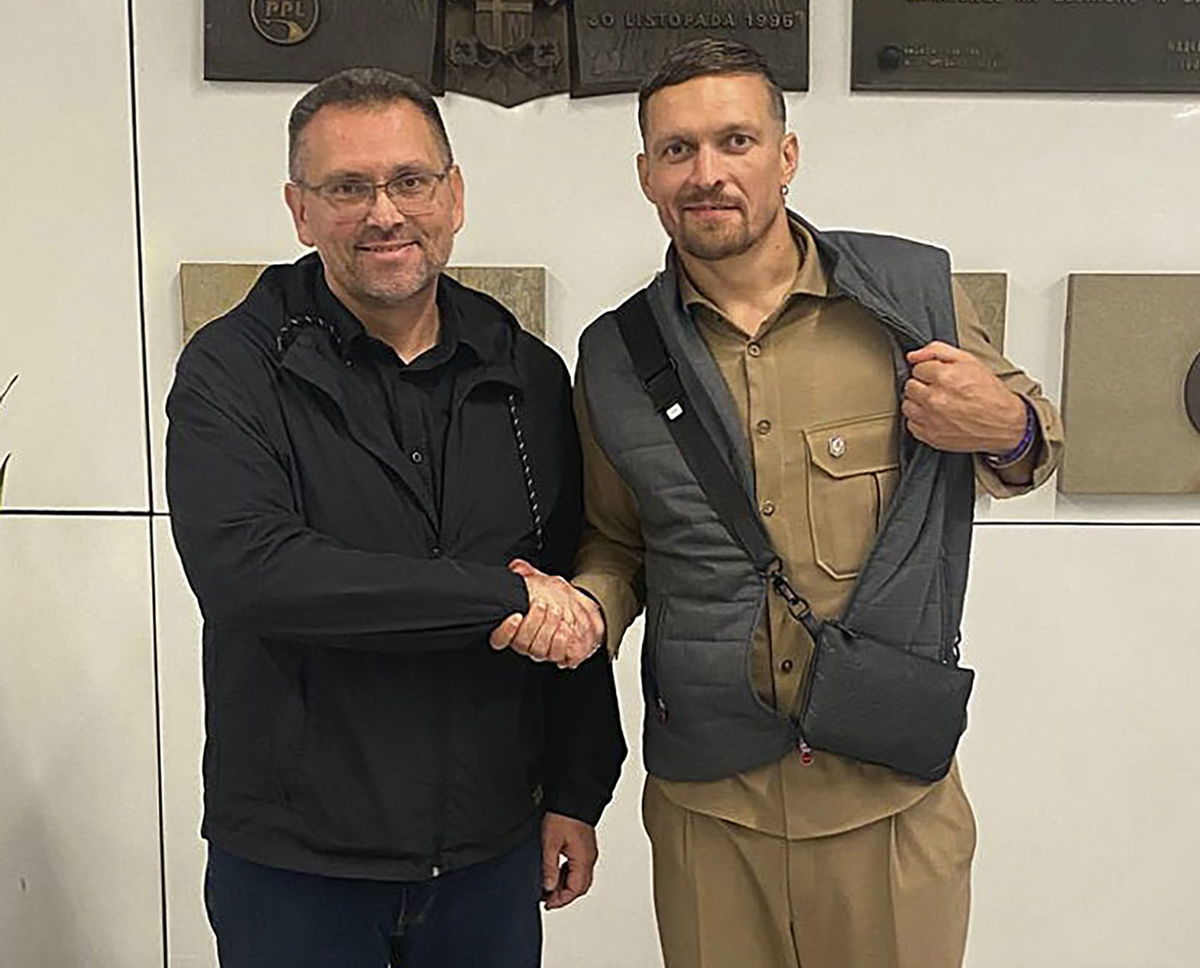 <i>Ukrainian Presidential Office/AP via CNN Newsource</i><br/>Heavyweight boxing champion Oleksandr Usyk (right) shakes hands with the Ukrainian Consul General in Krakow