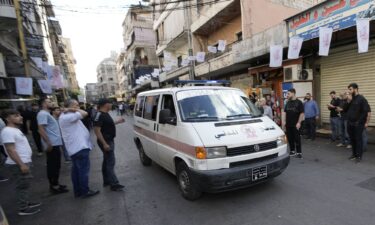 An ambulance drives through a southern suburb of Beirut after explosions were heard.