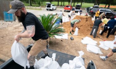 People bag sand in preparation for possible flooding as Tropical Storm Helene heads toward the state's Gulf Coast on September 25 in Tallahassee