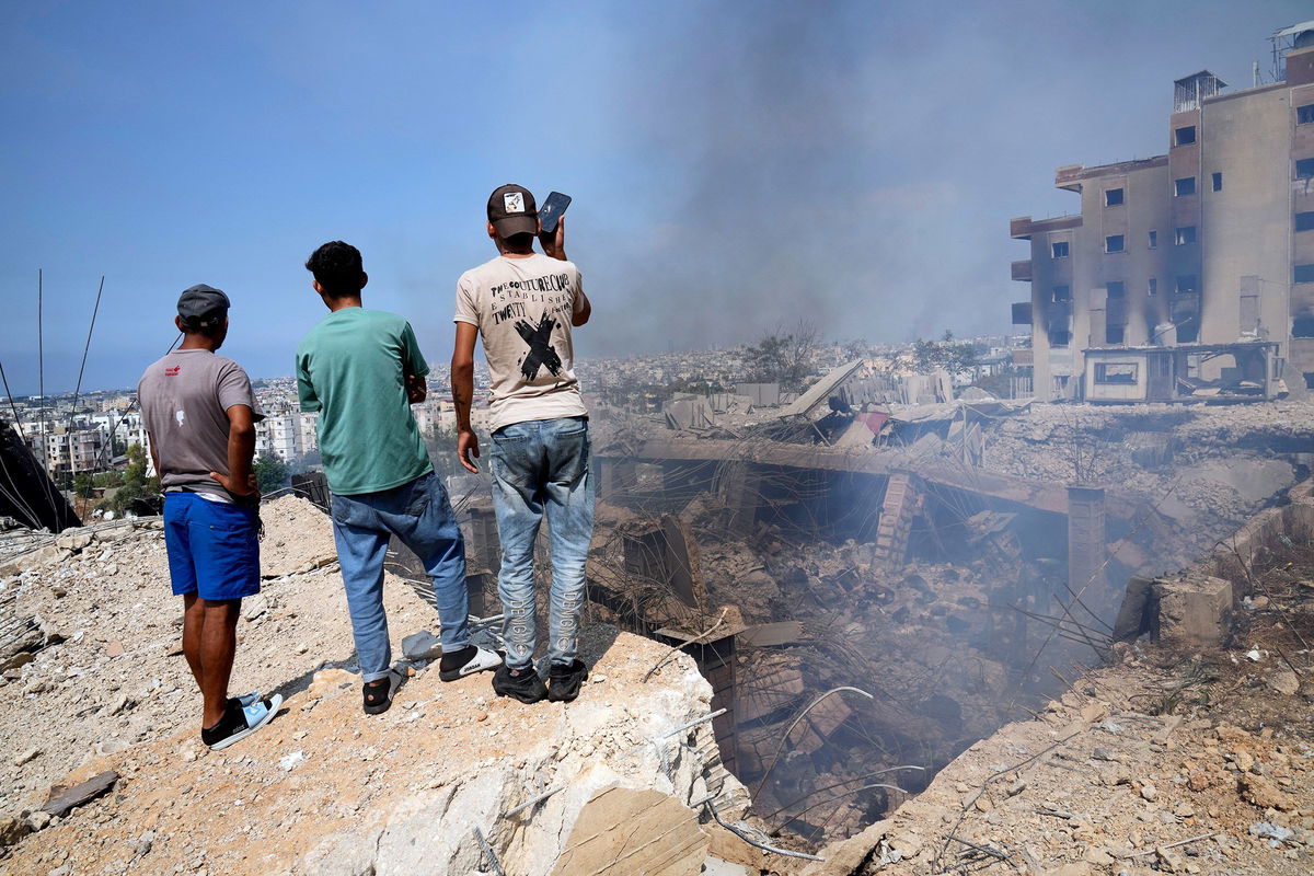 <i>AFP/Getty Images via CNN Newsource</i><br />A man rides his motorbike through a neighborhood leveled by Israeli strikes in the Hadath district of Beirut's southern suburbs on September 28.