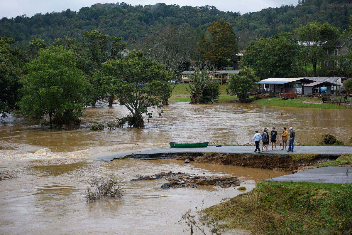 <i>Melissa Sue Gerrits/Getty Images via CNN Newsource</i><br />Residents talk after having canoed the flooded South Fork New River for 32 minutes and landing at a washed out road on September 27