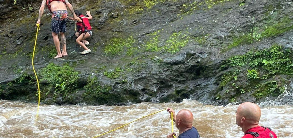 <i>Maui Fire Department/KITV via CNN Newsource</i><br/>A girl and a man are safe from rising waters after Maui firefighters performed two rescues at Iao Valley.