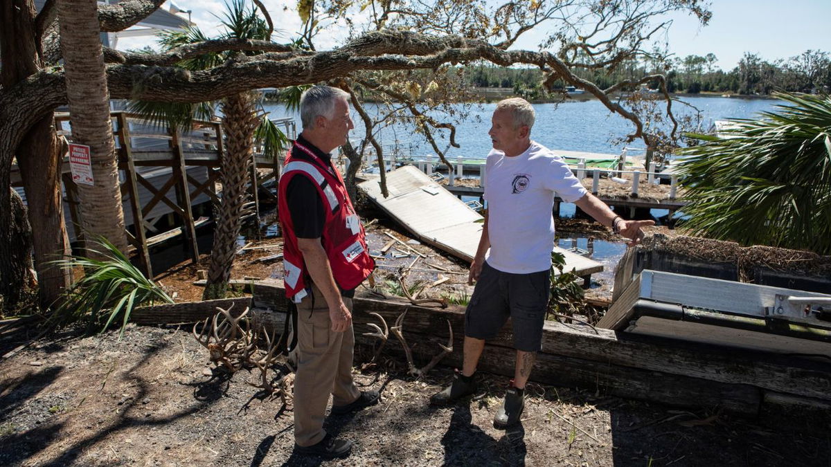 Kim Mailes, a volunteer from the Colorado and Wyoming region, offers support to Garry in his hometown of Steinhatchee, Florida, after Hurricane Helene devastated the area. 