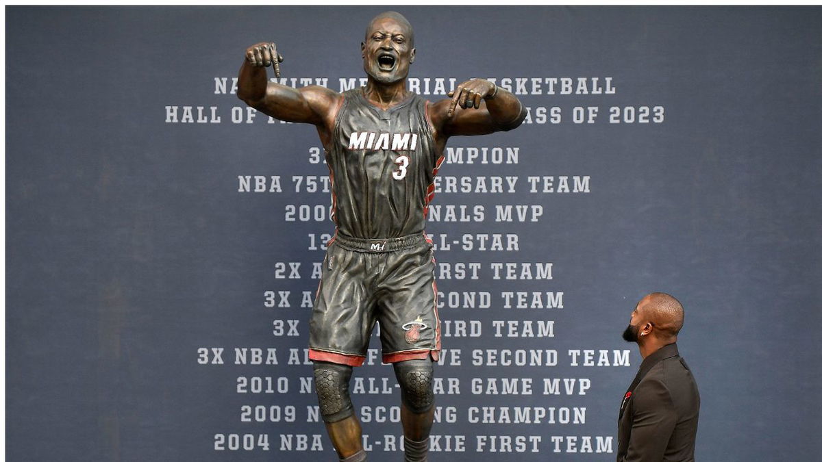 Wade looks at his bronze statue at the unveiling ceremony.
