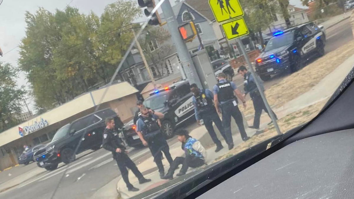 Image taken by a passerby shows officers standing around the presumed man who was in possession of the rifle and large-capacity magazine