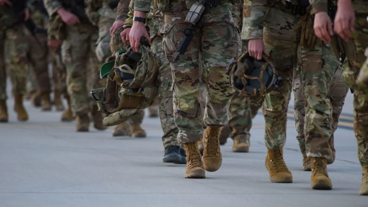 Soldiers walk across the tarmac to deploy to Poland on February 14, 2022. Melissa Sue Gerrits/Getty Images