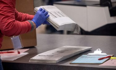 Election workers sort ballots at the Maricopa County Tabulation and Election Center in November 2022 in Phoenix