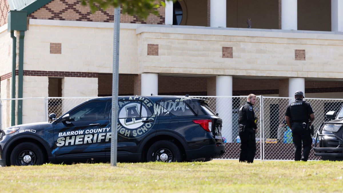 <i>Jessica McGowan/Getty Images via CNN Newsource</i><br/>Officers stand outside Apalachee High School on September 5 in Winder