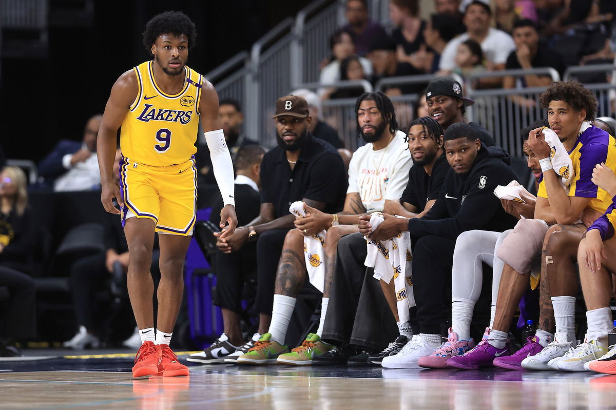 <i>Sean M. Haffey/Getty Images via CNN Newsource</i><br/>LeBron James watches the game from the bench as Bronny James makes his preseason debut.