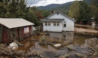 An American flag hangs above floodwaters remaining from Hurricane Helene on Friday