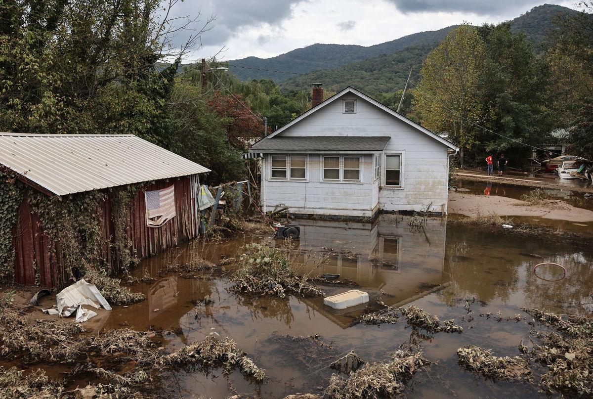 <i>Mario Tama/Getty Images via CNN Newsource</i><br />An American flag hangs above floodwaters remaining from Hurricane Helene on Friday