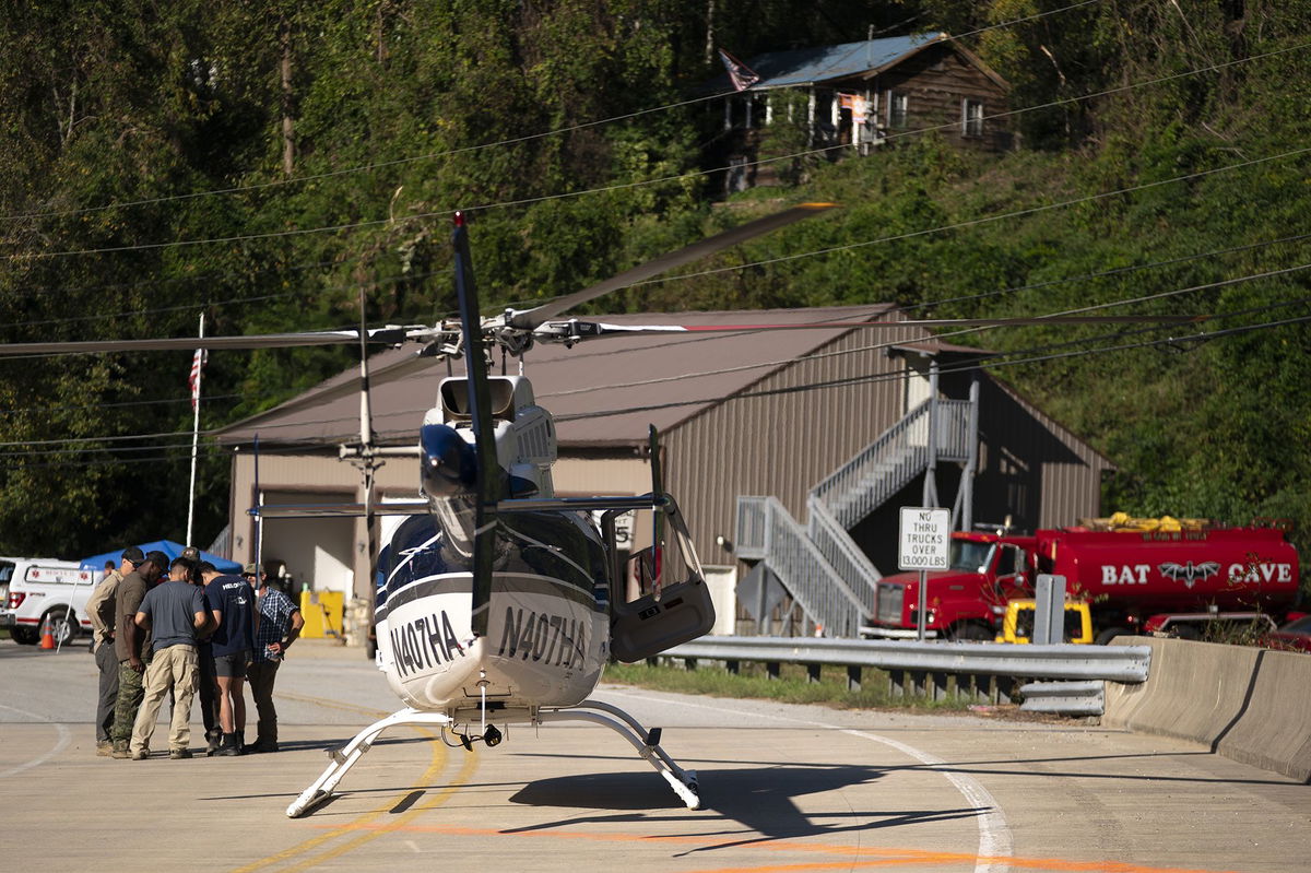 <i>Sean Rayford/Getty Images via CNN Newsource</i><br/>A helicopter pilot meets with people on the ground in the aftermath of Hurricane Helene on October 3