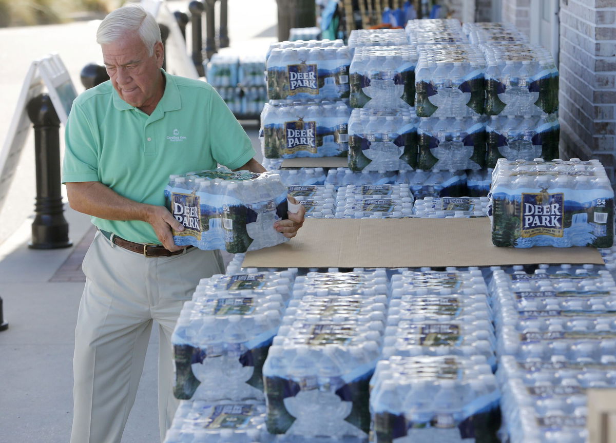 <i>Mic Smith/AP via CNN Newsource</i><br/>Larry Pierson purchases bottled water from the Harris Teeter grocery store on the Isle of Palms in preparation for Hurricane Florence in September 2018.