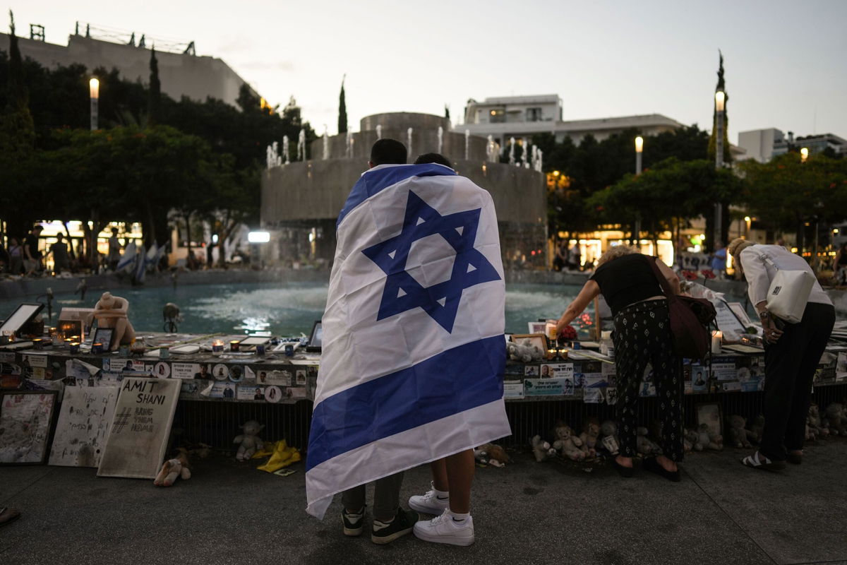 <i>Oded Balilty/AP via CNN Newsource</i><br/>People look at a memorial for victims of the cross-border attack by Hamas militants on the one-year anniversary in Tel Aviv