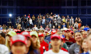 Members of the press stand at the back of a rally for former President Donald Trump in Bozeman