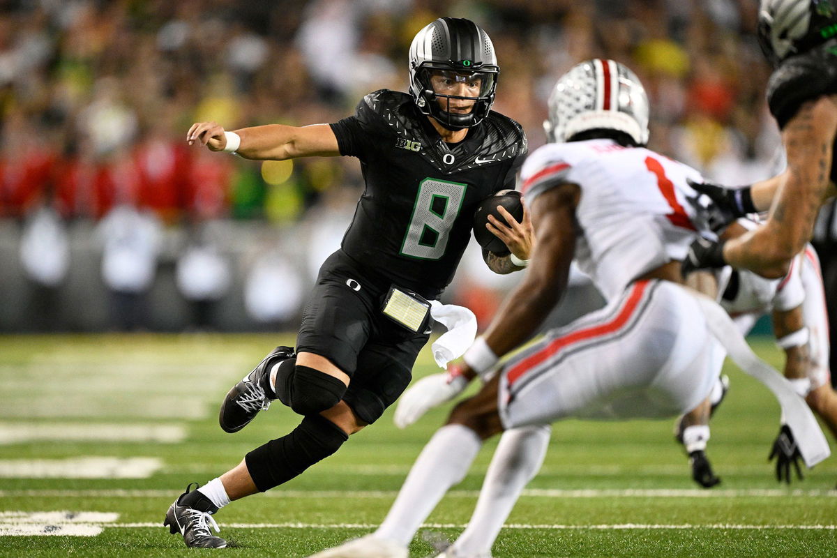 <i>Troy Wayrynen/USA Today Sports/Reuters via CNN Newsource</i><br/>Oregon Ducks fans swarm the field after the game.