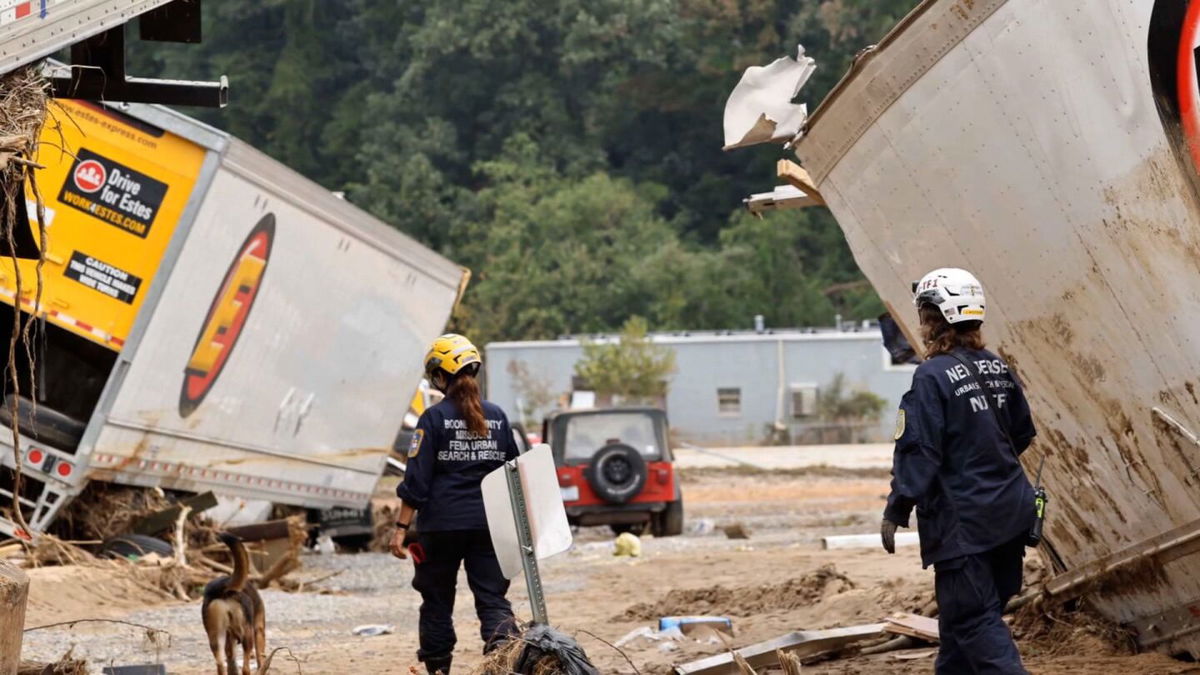 <i>Getty Images via CNN Newsource</i><br/>Members of the FEMA Urban Search and Rescue Task Force search a flood damaged area with a search canine in the aftermath of Hurricane Helene along the Swannanoa River on October 4