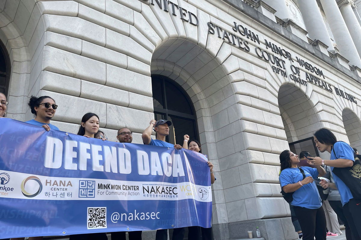 <i>Kevin McGill/AP via CNN Newsource</i><br/>Demonstrators supporting Biden Administration efforts to protect immigrants brought to the US illegally when they were children hold signs in front of the federal appeals court in New Orleans on Thursday