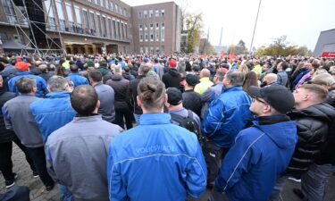 A Volkswagen employee holds a placard reading "Hands off the collective agreement" during a VW works council event in Zwickau