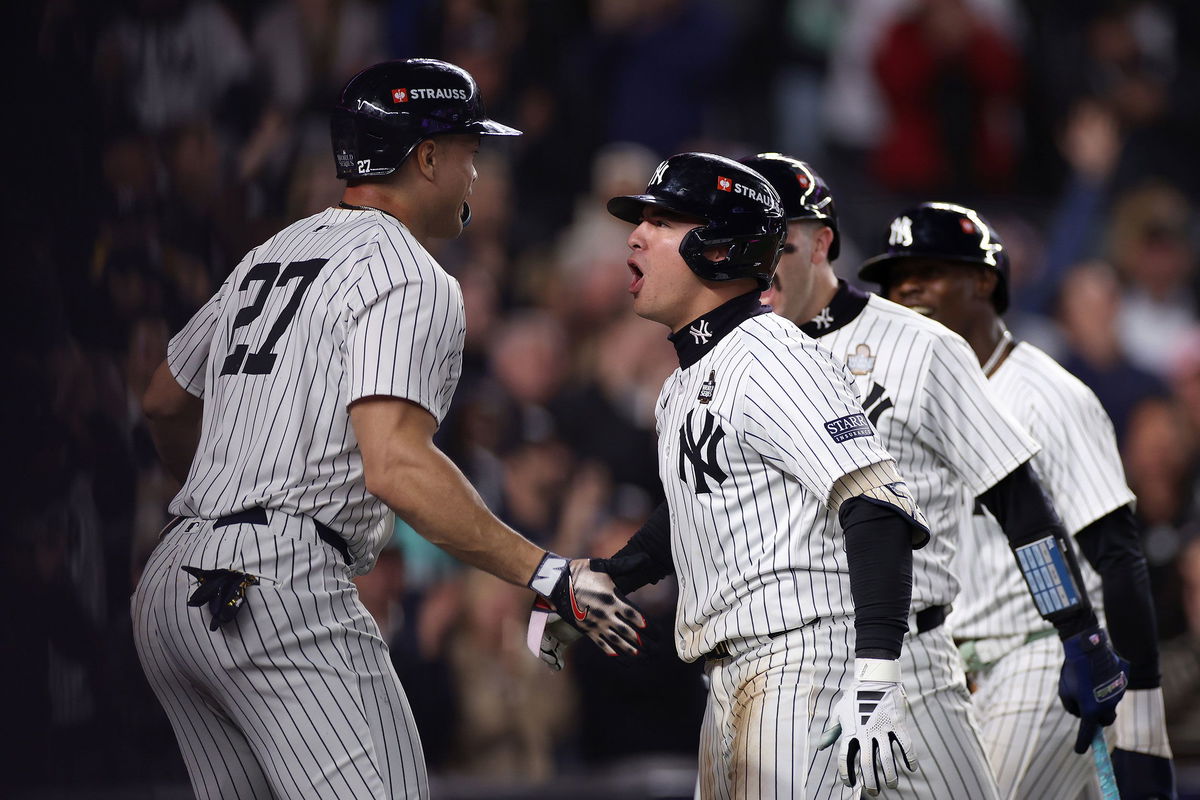 <i>Sarah Stier/Getty Images via CNN Newsource</i><br/>Anthony Volpe is congratulated by his teammates after hitting a grand slam in Game 4.