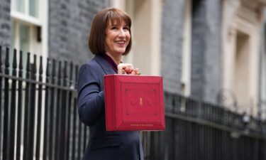 Britain's finance minister Rachel Reeves poses with the red budget box outside her office in Downing Street in London on Wednesday