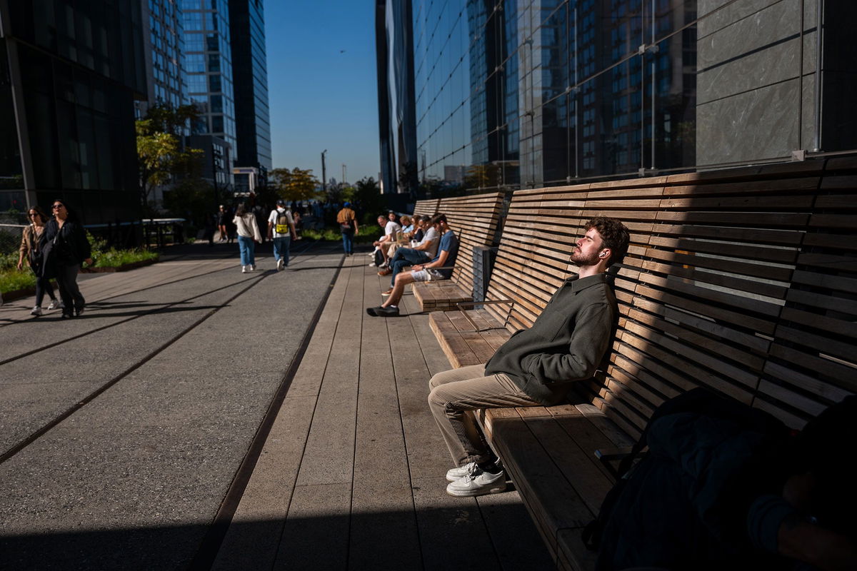 <i>Spencer Platt/Getty Images via CNN Newsource</i><br/>People rest in the sun along the High Line on a sunny and unusually warm day in New York City on October 21.