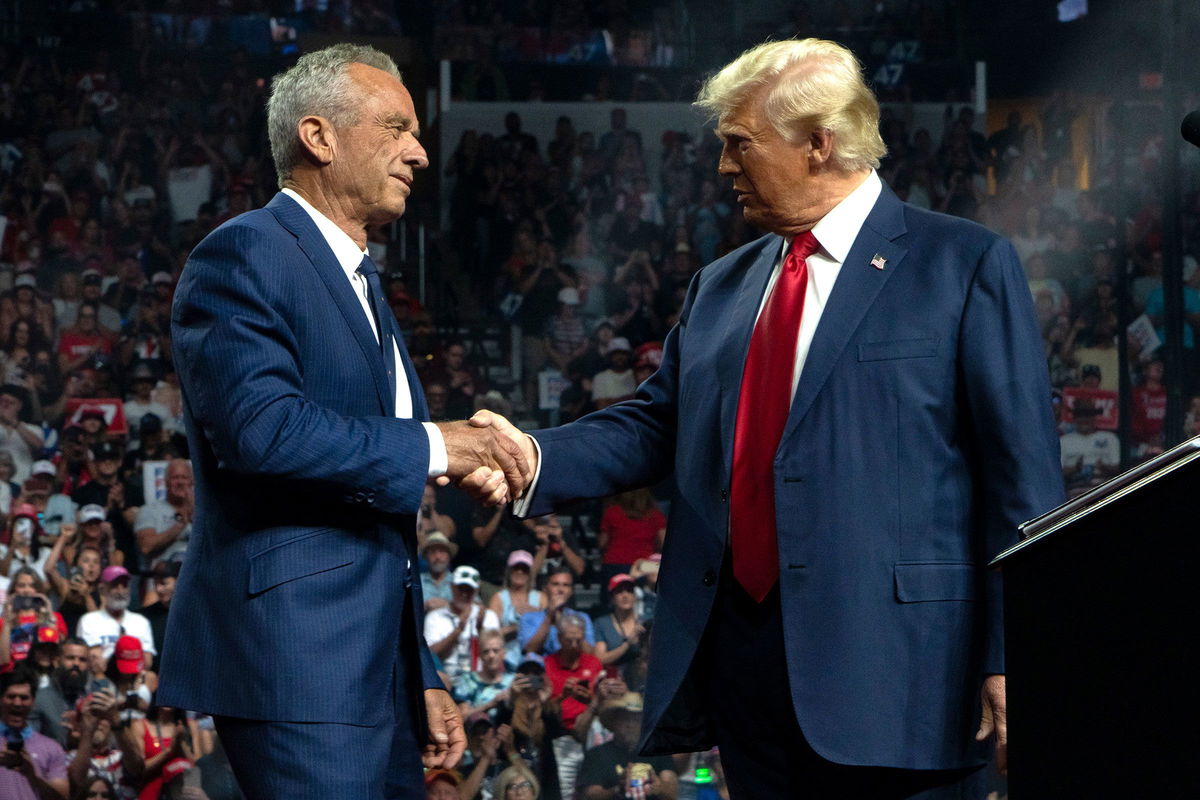 <i>Rebecca Noble/Getty Images via CNN Newsource</i><br/>Robert F. Kennedy Jr. and former President Donald Trump shake hands during a campaign rally at Desert Diamond Arena on August 23