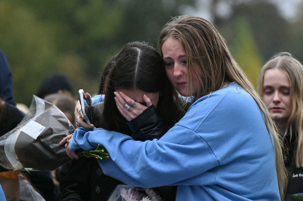 <i>Justin Tallis/AFP/Getty Images via CNN Newsource</i><br />Fans comforting each other while paying tribute to Liam Payne at a memorial held on Sunday in London's Hyde Park.