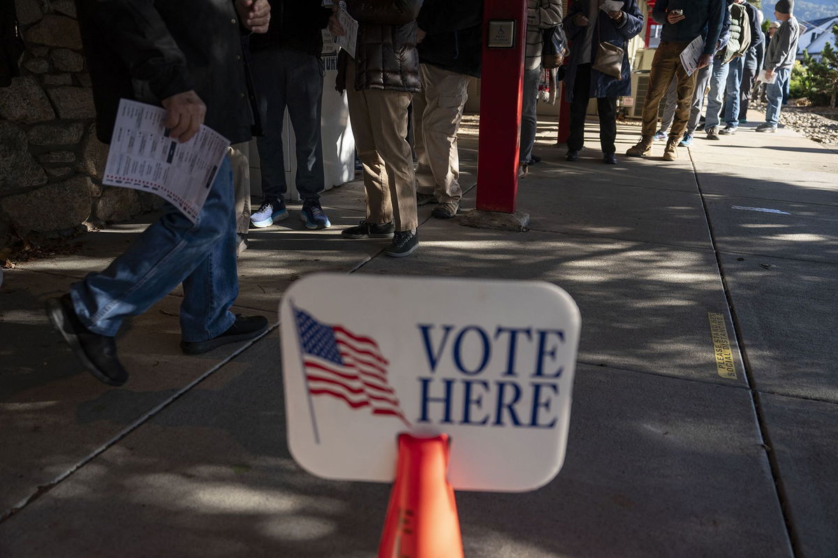 <i>Allison Joyce/AFP/Getty Images via CNN Newsource</i><br />People wait in line to cast their ballots during early voting at a polling station in Black Mountain