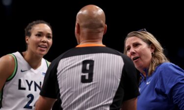 Minnesota Lynx forward Napheesa Collier and head coach Cheryl Reeve discuss a foul call with a game official in the fourth quarter of Game Five of the WNBA Finals.