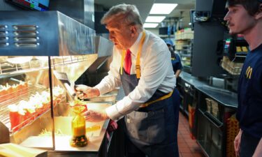 Donald Trump works behind the counter making french fries during a visit to McDonald's restaurant on October 20