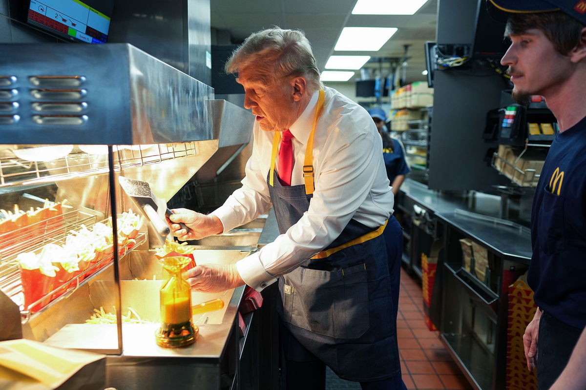 <i>Doug Mills/Pool/Getty Images via CNN Newsource</i><br/>Donald Trump works behind the counter making french fries during a visit to McDonald's restaurant on October 20