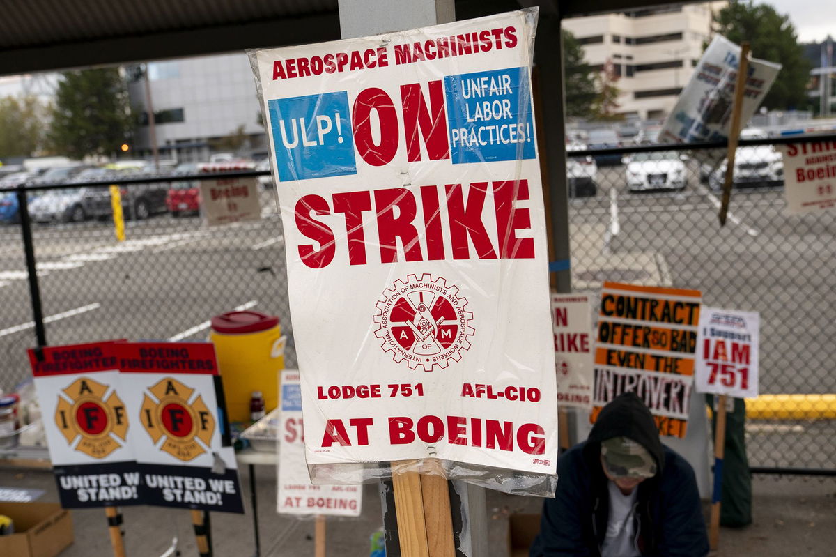 <i>David Ryder/Getty Images via CNN Newsource</i><br/>Boeing workers gather on a picket line during an ongoing strike on October 24 in Seattle.