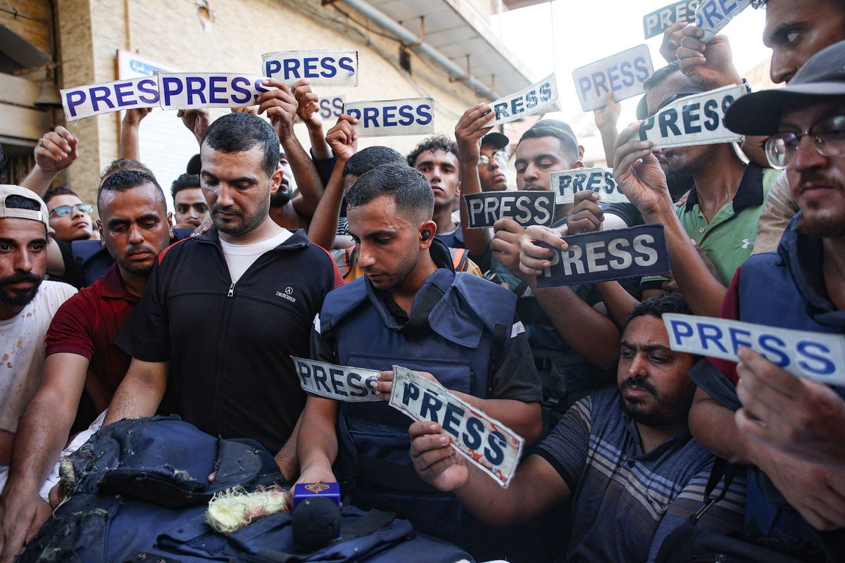 <i>Omar Al-Qattaa/AFP/Getty Images via CNN Newsource</i><br/>Mourners and colleagues hold 'press' signs around the body of Al-Jazeera Arabic journalist Ismail al-Ghoul