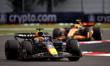 Sainz celebrates on the podium with Lando Norris and teammate Charles Leclerc.