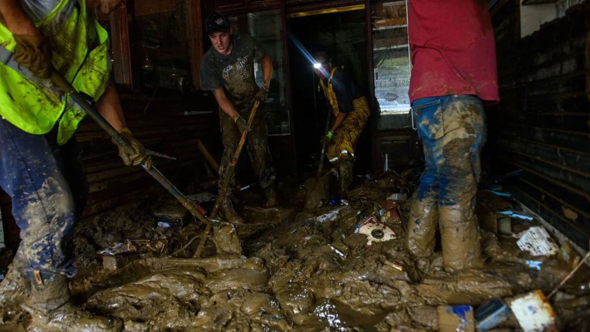 Friends help Sam Soughail, third from left, clear out his cigar bar at the Biltmore Village in Asheville, North Carolina, on October 1, 2024, in the aftermath of Hurricane Helene. Melissa Sue Gerrits/Getty Images