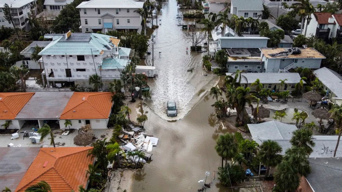 In this aerial photo, a vehicle drives through a flooded street after Hurricane Milton in Siesta Key, Florida, on October 10, 2024. Chandan Khanna/AFP/Getty Images