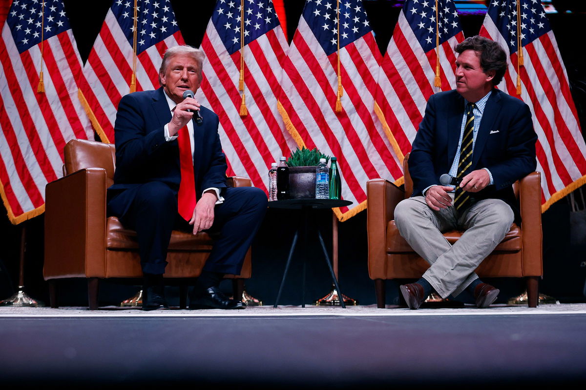 <i>Chip Somodevilla/Getty Images via CNN Newsource</i><br/>Former President Donald Trump sits down with Tucker Carlson during his Live Tour at the Desert Diamond Arena on October 31