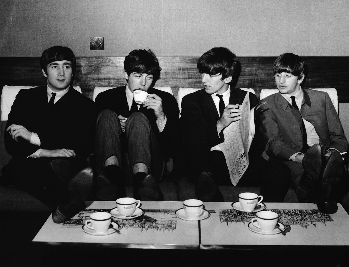 <i>Fox Photos/Getty Images via CNN Newsource</i><br/>The Beatles take a break from their rehearsals with a coffee after lunch at the Mapleton Hotel in November 1963.