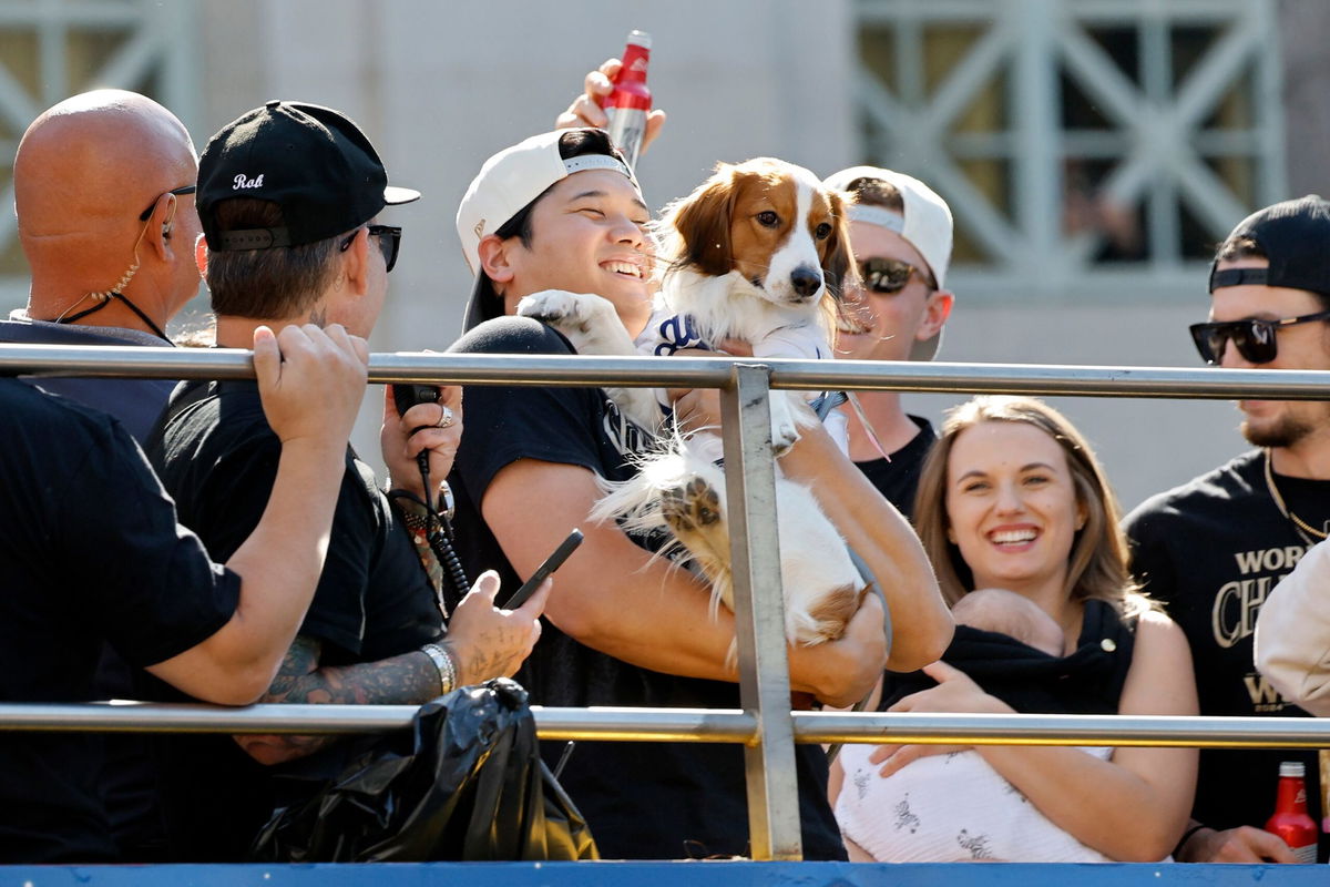 <i>Kevork Djansezian/Getty Images via CNN Newsource</i><br/>Shohei Ohtani celebrates on the bus with his dog Decoy during the Dodgers' victory parade.