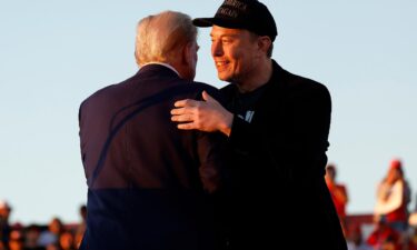 Elon Musk embraces former President Donald Trump during a campaign rally at the Butler Farm Show fairgrounds on October 5 in Butler