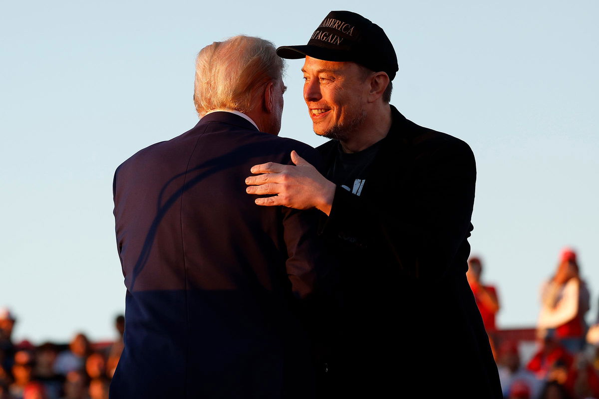 <i>Anna Moneymaker/Getty Images via CNN Newsource</i><br/>Elon Musk embraces former President Donald Trump during a campaign rally at the Butler Farm Show fairgrounds on October 5 in Butler