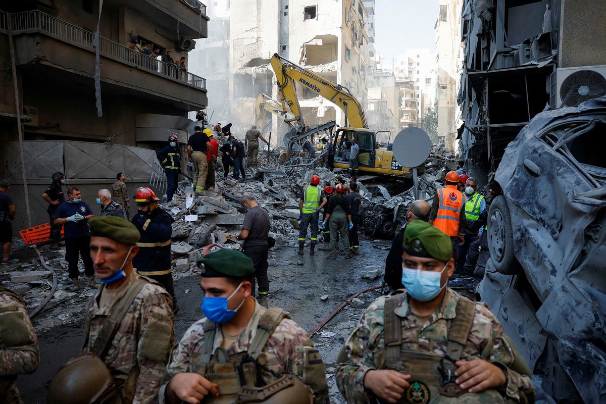 <i>Adnan Abidi/Reuters via CNN Newsource</i><br />Civil defense members work as Lebanese army soldiers stand guard at the site of an Israeli strike in the Basta neighborhood of Beirut