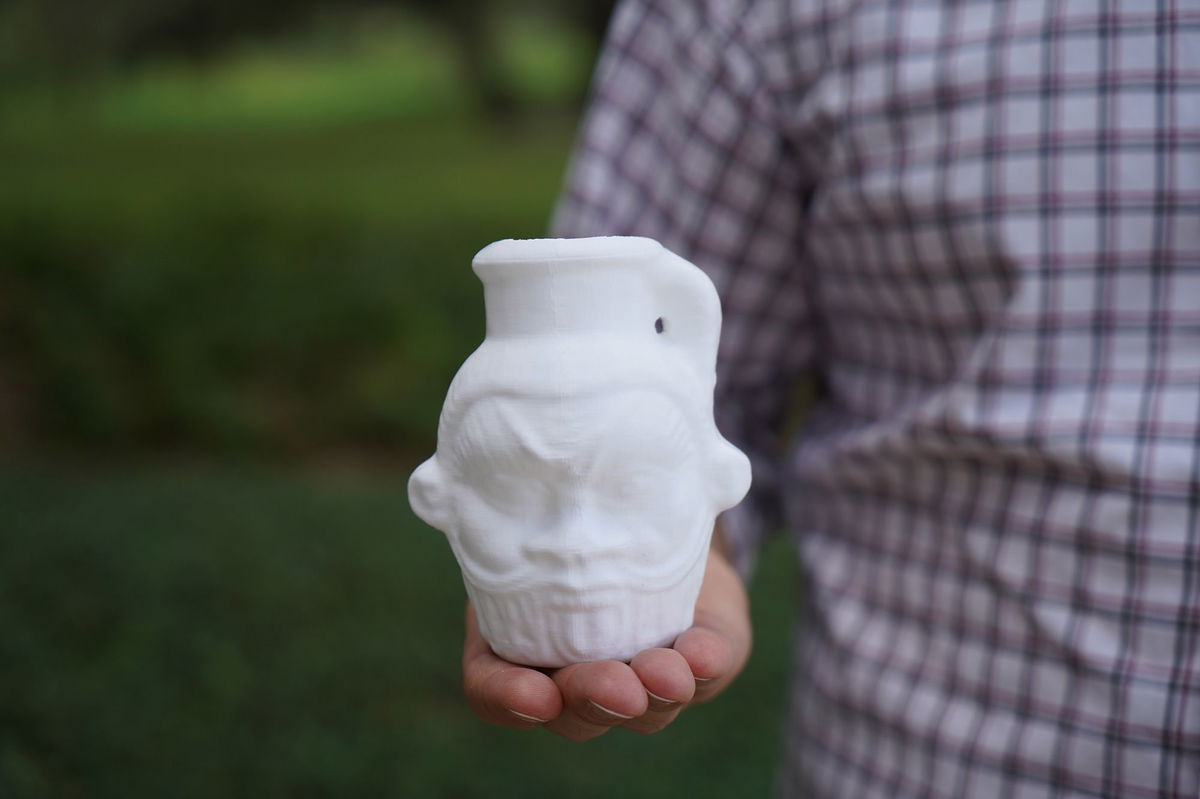 <i>Cassidy Delamarter via CNN Newsource</i><br/>Davide Tanasi holds a 3D-generated replica of the Egyptian Bes mug.