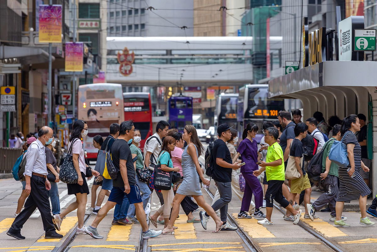 <i>Paul Yeung/Bloomberg/Getty Images via CNN Newsource</i><br/>Pedestrians cross a street in Hong Kong on June 25.