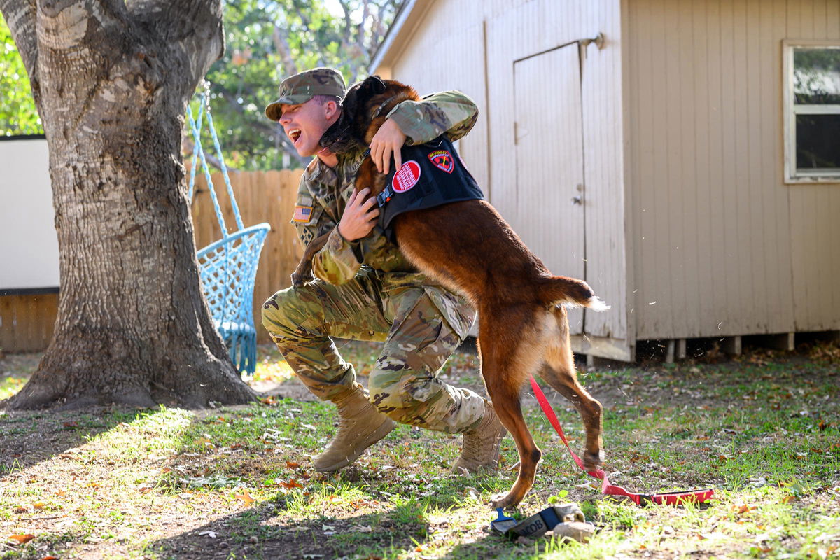 <i>Chris Saucedo/Getty Images via CNN Newsource</i><br/>May reunites Monday with his retiring military working dog